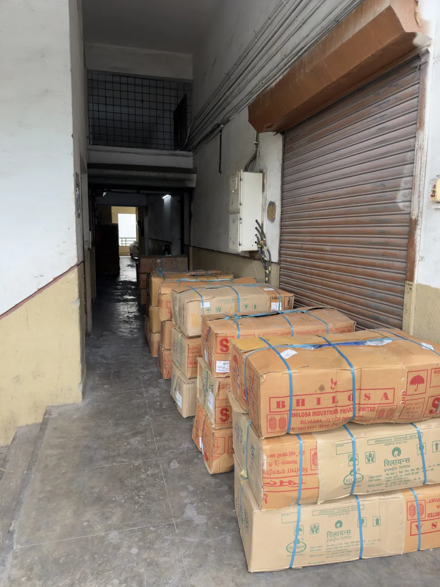Strapped cartons of finished footwear stacked at the factory dispatch bay